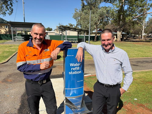 Ross and Tom standing near drinking fountain